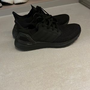 2 pairs of Adidas ultraboosts. One all black the other white and gold